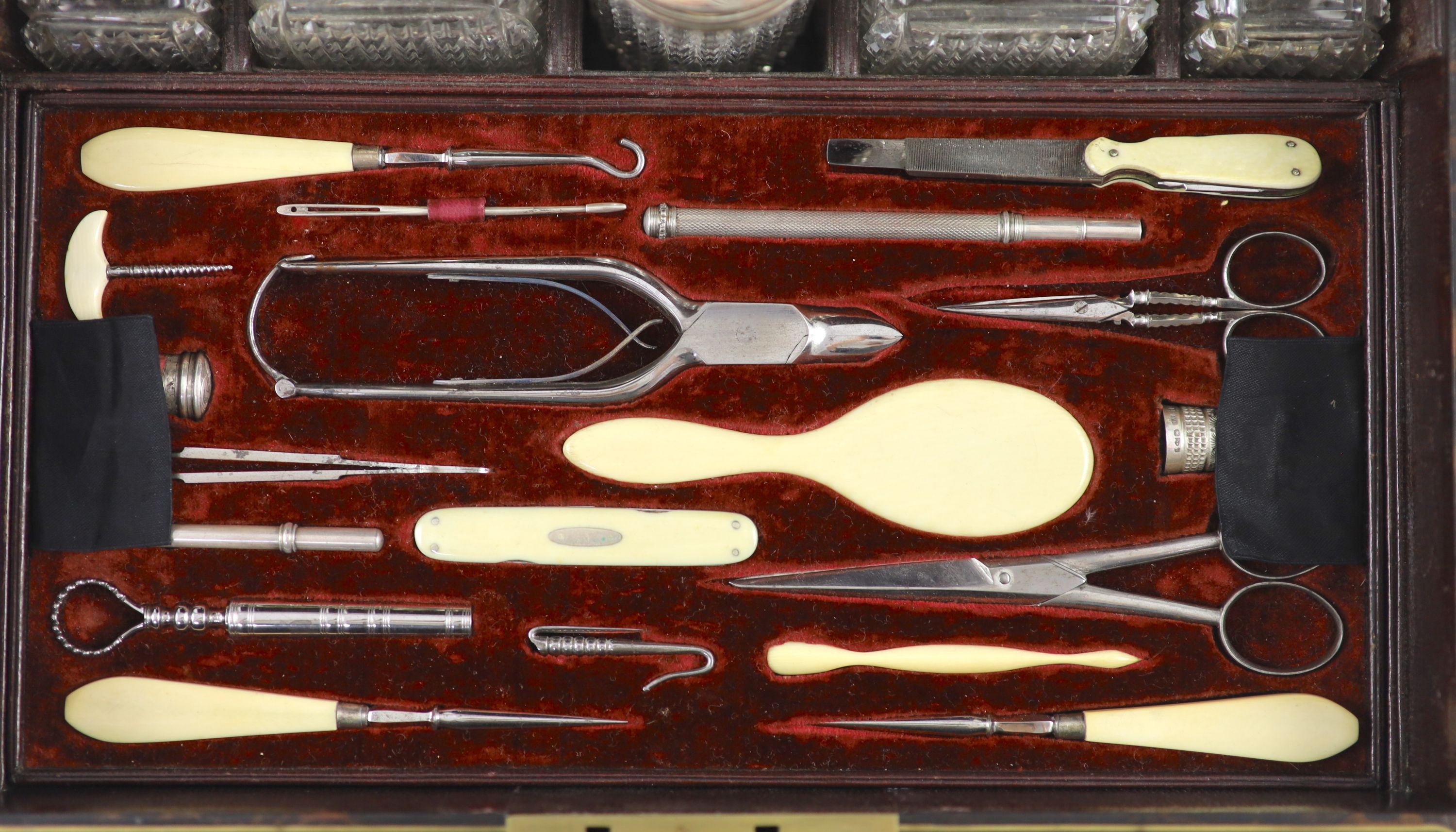 A good late William IV brass inlaid two handled coromandel wood travelling toilet set, containing eleven silver mounted glass jars etc.